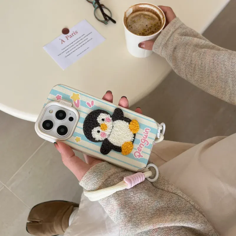 Penguin iPhone 16 case with double-hook wrist strap